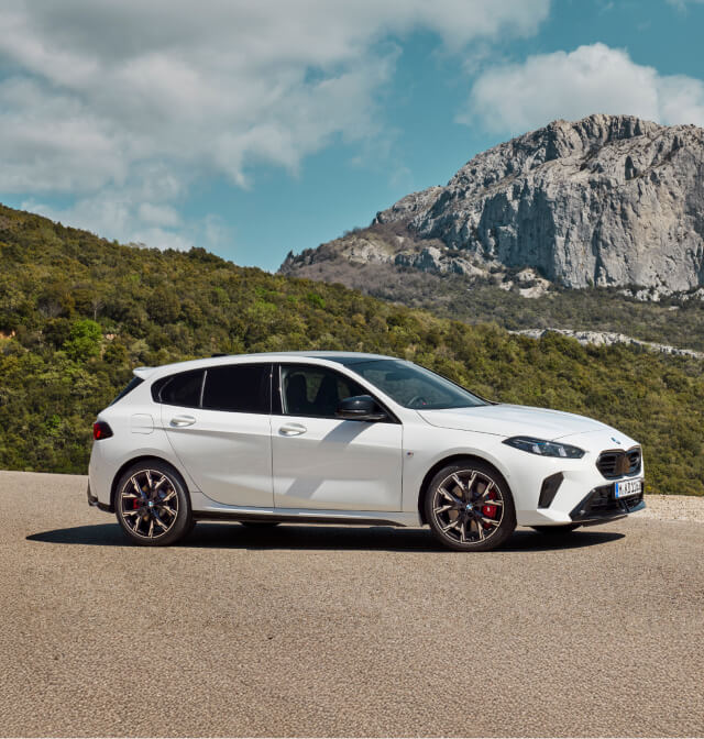 Side view of BMW 1 series parked in mountain background