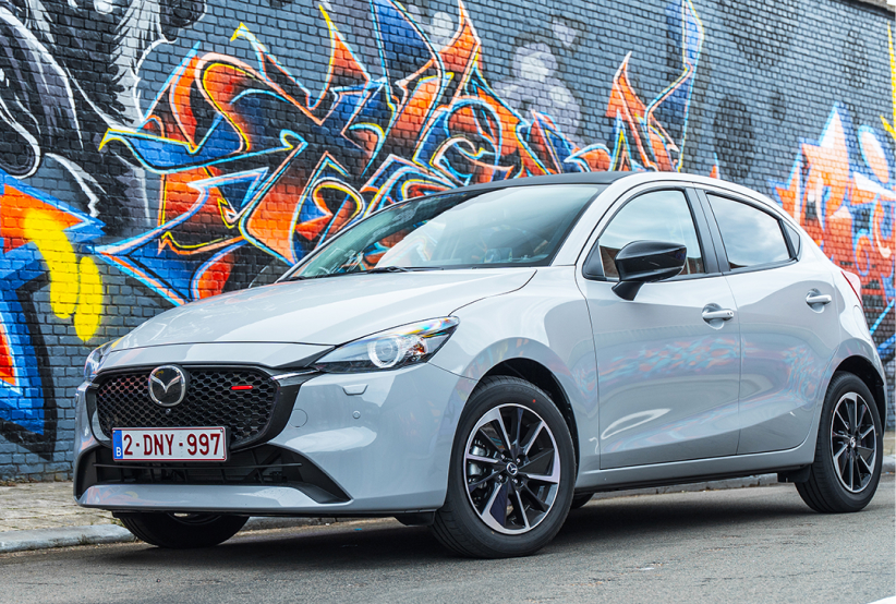 Silver Mazda2 infront of a wall