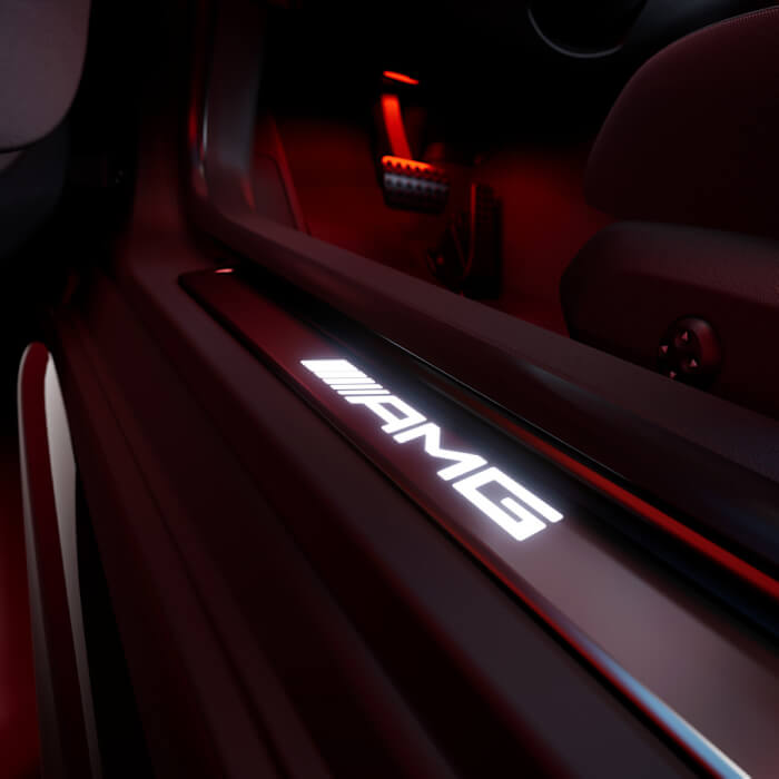 Close AMG door sill with glowing AMG lettering