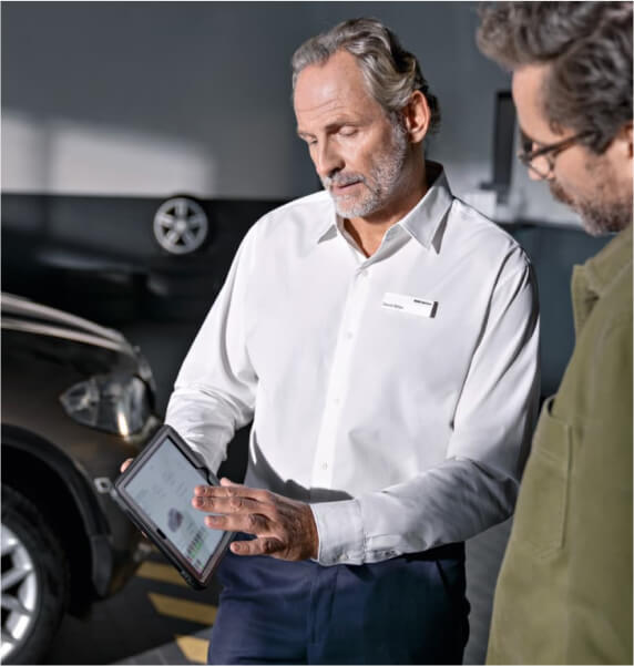 Two people looking at a tablet