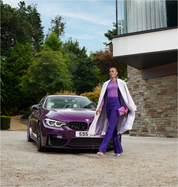 Woman next to a purple BMW