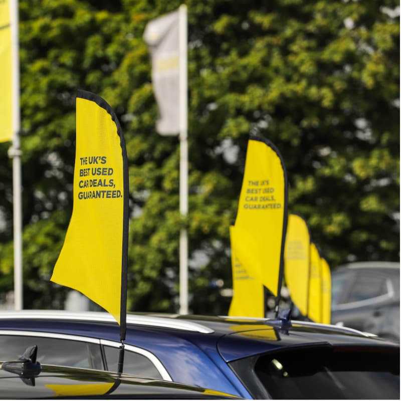 Arnold Clark Forecourt with Best Deal Guaranteed flags